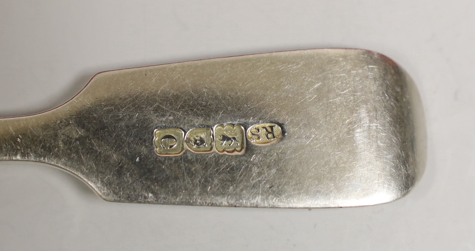 An early 20th century matched part canteen of fiddle pattern silver flatware, comprising thirty items, mainly Robert Stebbings, London 1900, 57.2oz and a plated spoon.